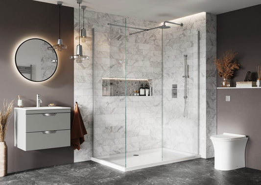 Modern bathroom with shower enclosure, sink, and toilet.